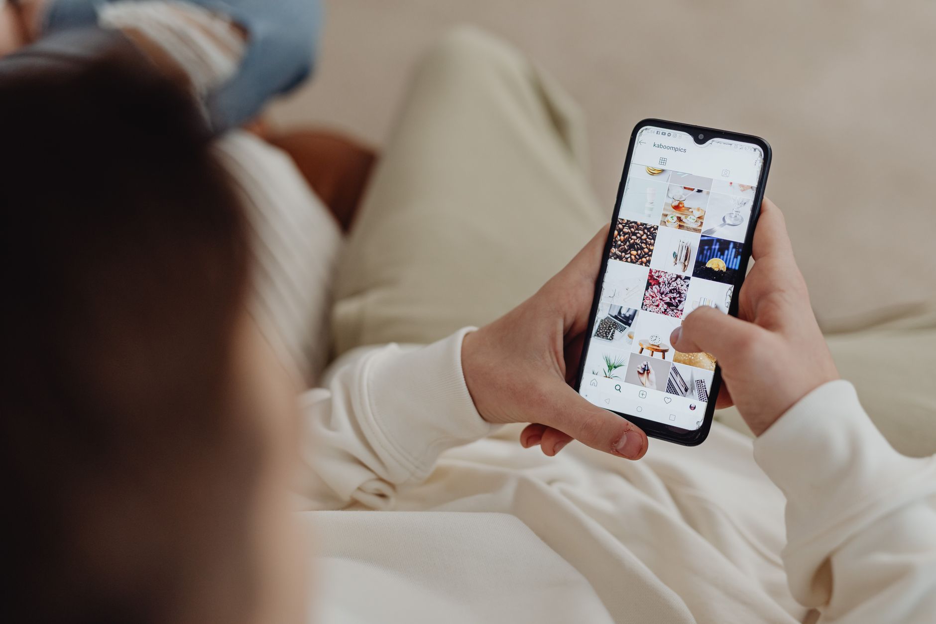 Person scrolling through social media on a smartphone