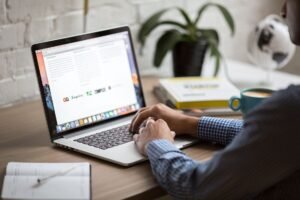 Small business owner managing email marketing campaign on laptop