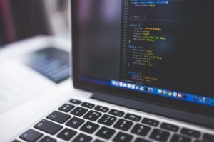 Person building a website on laptop computer screen step by step guide