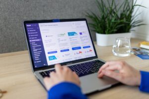 Small business owner reviewing services page on laptop