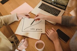 Small business owner implementing marketing ideas on laptop for business growth