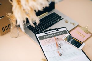 Small business owner reviewing pricing strategy and psychology on laptop